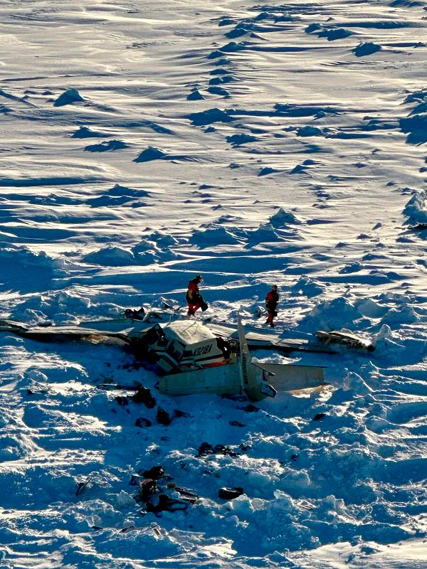 Authorities inspect the wreckage of the Cessna 208B Grand Caravan aircraft operated by Bering Air, that suddenly lost altitude and went missing with 10 people on board on Thursday, near Nome, Alaska February 7, 2025. - U.S. Coast Guard/Handout via REUTERS