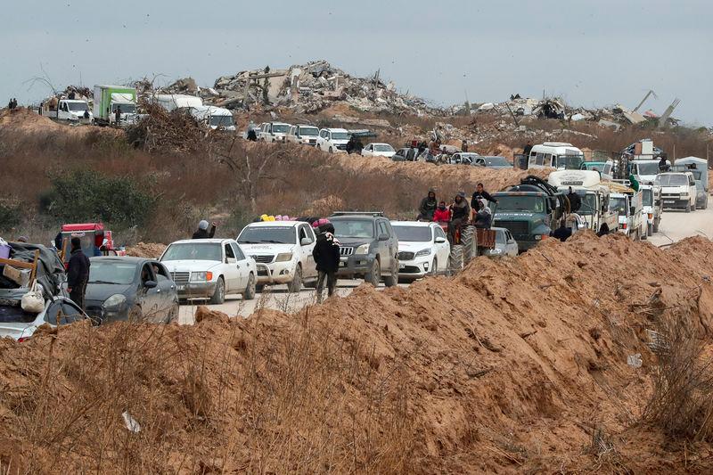 Palestinians wait to cross through a checkpoint run by U.S. and Egyptian security contractors after Israeli forces withdrew from the Netzarim Corridor, allowing people to travel in both directions between southern and northern Gaza, amid a ceasefire between Israel and Hamas, near Gaza City, February 9, 2025. - REUTERSPIX