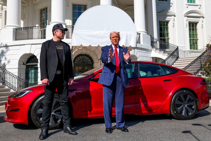 U.S. President Donald Trump talks to the media next to Tesla CEO Elon Musk, with a Tesla car in the background, at the White House in Washington, D.C. on March 11, 2025. REUTERSpixS