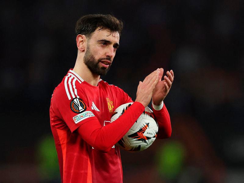 Manchester United’s Bruno Fernandes celebrates with the match ball after the match. REUTERSpix