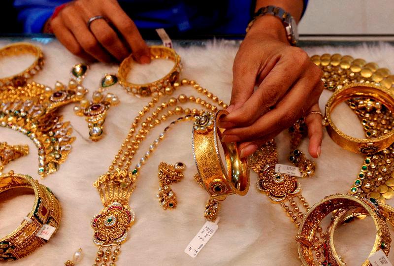 For representational purposes- a woman looks at a gold bangle inside a jewellery showroom at a market in Mumbai-Filepix. AFPpix