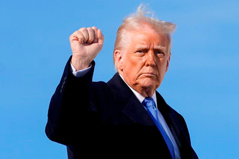 U.S. President Donald Trump gestures, as he boards Air Force One to depart for New Jersey at Joint Base Andrews, Maryland, U.S. REUTERSpix