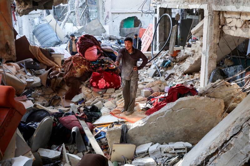 A Palestinian man inspects the site of an Israeli strike on a house, in Bureij in the central Gaza Strip.REUTERSpix