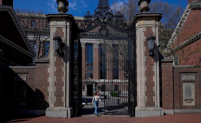A woman walks on the campus of Harvard University in Cambridge, Massachusetts, U.S., April 15, 2025. - REUTERS/Faith Ninivaggi/File Photo