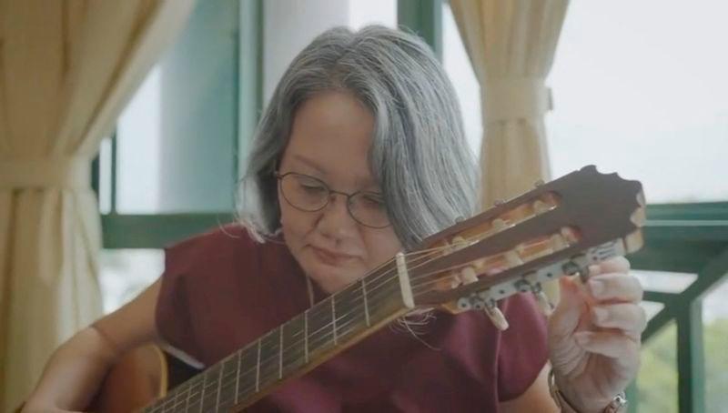 Sylvia Lim, the chair of the Workers’ Party in Singapore, tunes a guitar as she introduces herself as the Candidate of the 2025 General Election, at an unknown location, in this screen grab taken from a handout video released on April 26, 2025. AFPpix
