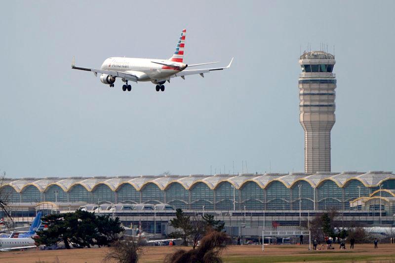FILEpix: An American Airlines Embraer ERJ-190AR airplane flies past the tower where air traffic controllers work despite not receiving their paychecks, on the 22nd day of a partial government shutdown at Reagan National Airport in Washington, U.S., January 12, 2019. REUTERS
