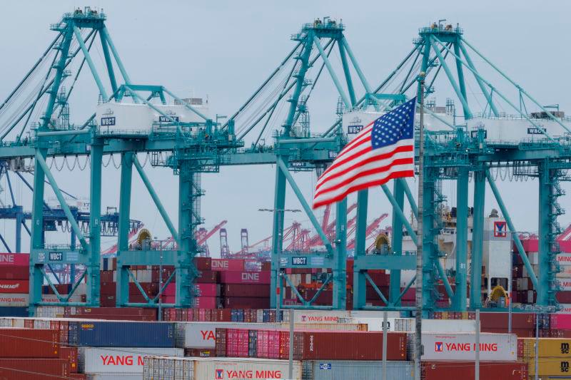 A U.S. flag flutters near shipping containers at the Port of Los Angeles, in San Pedro, California, U.S., May 1, 2025. REUTERSpix