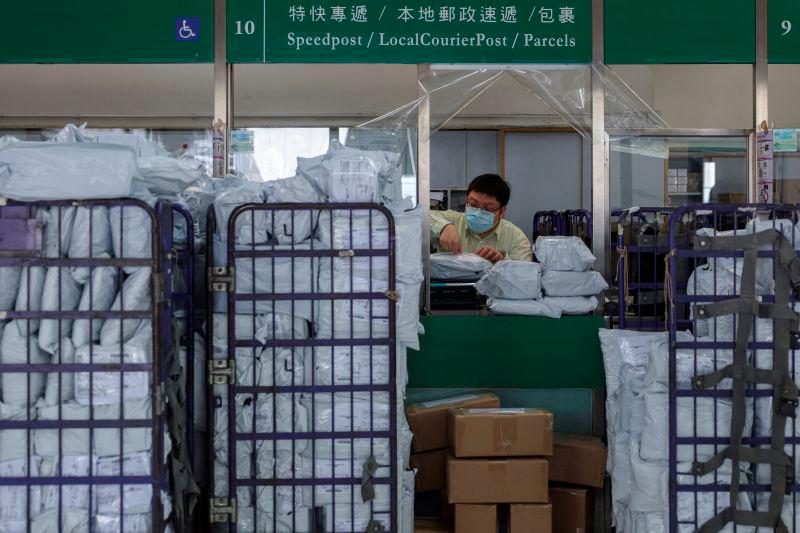 A postal worker processes parcels at a post office as Hong Kong Post restricts U.S.-bound shipments due to new U.S. tariff rules, in Hong Kong, China, May 2, 2025. REUTERSpix