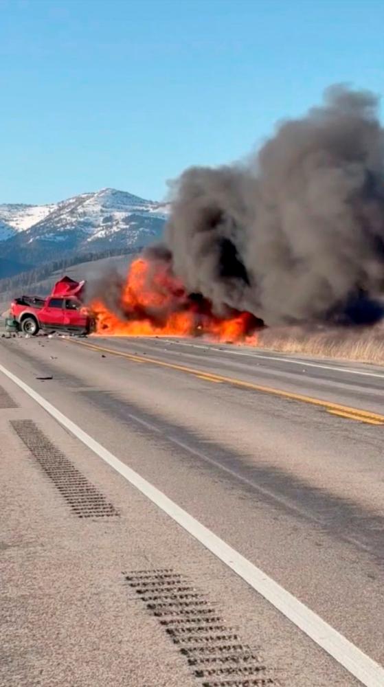 Flames rise near a pickup truck following a two-vehicle crash with multiple fatalities, according to Idaho State Police, in Island Park, Idaho, U.S., May 1, 2025.