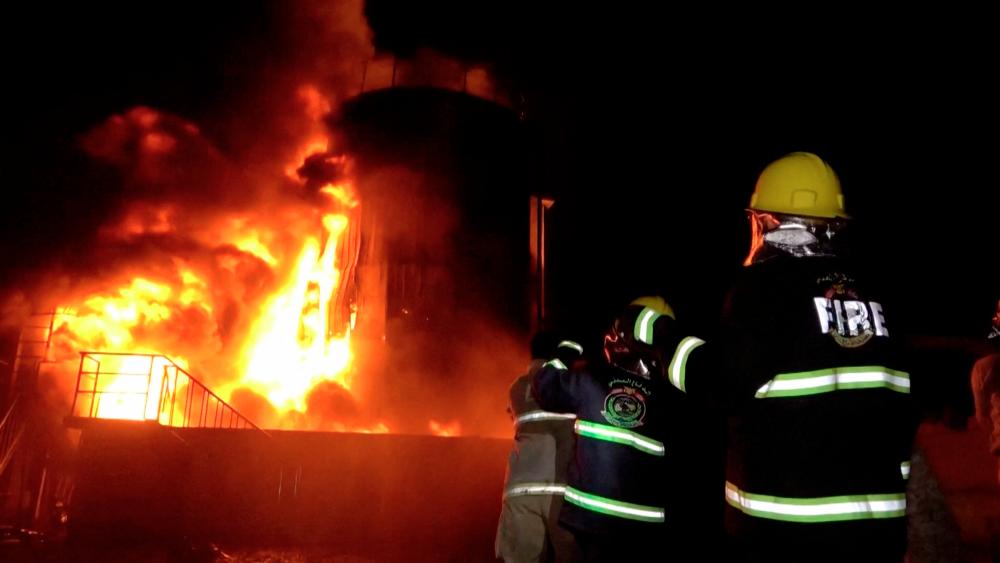 Firefighters work as huge fires erupted at a cement factory in Yemen after the Israeli military said it carried out airstrikes against Hodeidah Port and its vicinity, a day after the Iran-aligned Houthis fired a missile that struck near Israel's main airport, at Bajil District, Hodeidah Governate, Yemen, May 5, 2025, in this screengrab obtained from a handout video. AL-MASIRAH TV/Handout via REUTERS THIS IMAGE HAS BEEN SUPPLIED BY A THIRD PARTY NO RESALES. NO ARCHIVES.