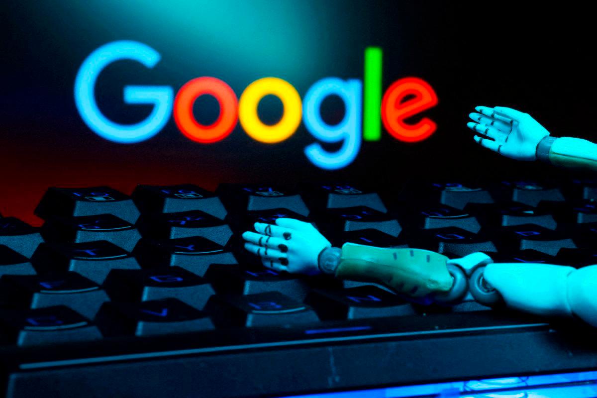 FILEpix The Google logo, a keyboard, and robot hands are seen in this illustration taken January 27, 2025. REUTERS