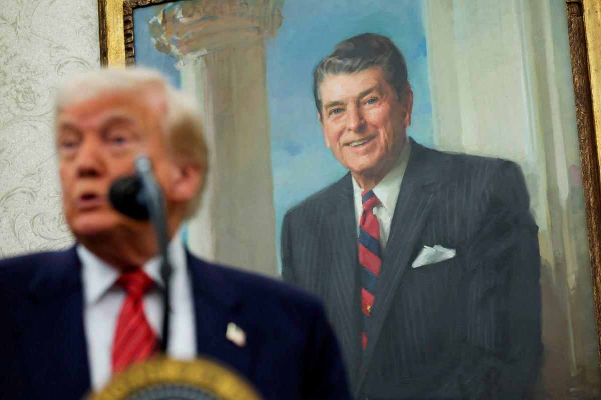 A portrait of former U.S. President Ronald Reagan is seen in the background as U.S. President Donald Trump speaks during a swearing-in ceremony for the new U.S. ambassador to China, former U.S. Senator David Perdue, at the White House in Washington, D.C., U.S., May 7, 2025. REUTERSpix