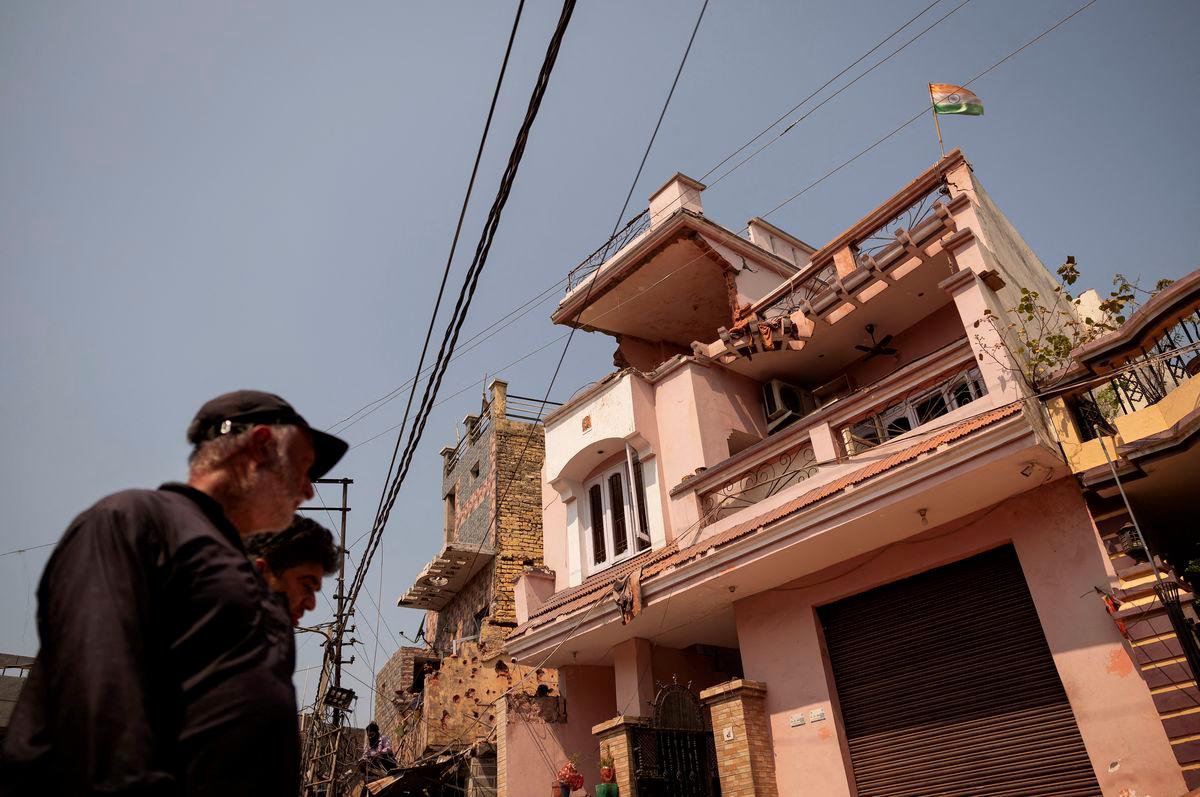An Indian flag is seen on top of a damaged house, following Pakistan's military operation against India, in Rehari, Jammu, May 10, 2025. - REUTERSPIX
