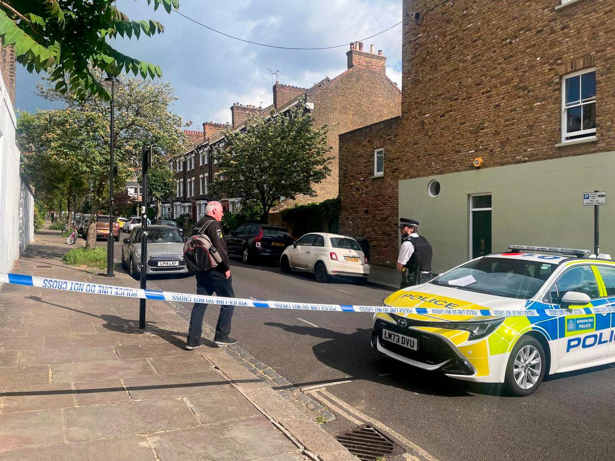 A person walks to a police officer at a cordoned off street, where a fire broke out at Britain's Prime Minister Keir Starmer's home in the early hours of Monday, in north London, Britain, May 12, 2025. - REUTERSPIX