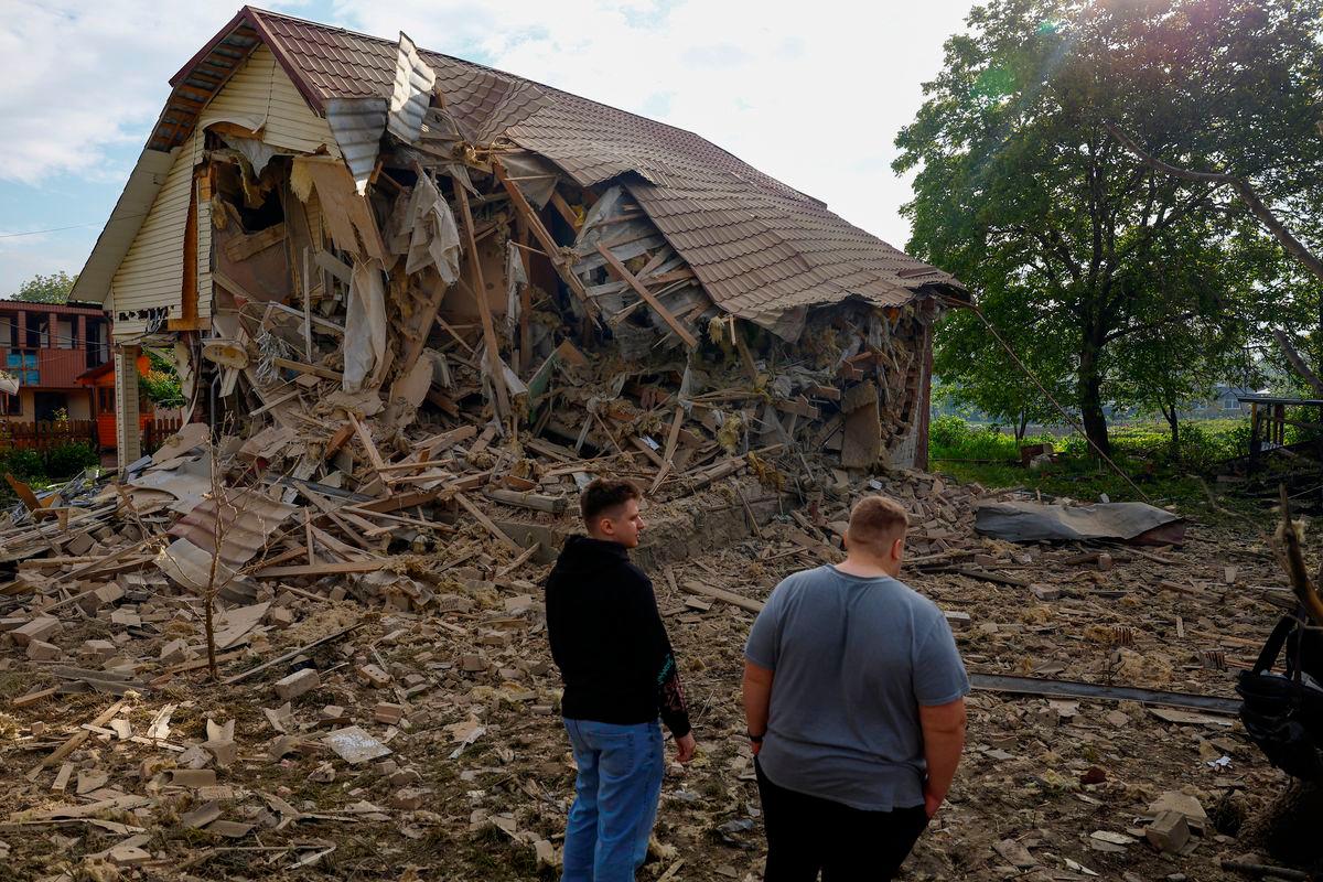 Resident Vadym Tsybenko, 22-year-old, and his relative stands next a house of his neighbours, heavily damaged by a Russian drone strike, amid Russia’s attack on Ukraine, outside of Kyiv, Ukraine. REUTERSpix
