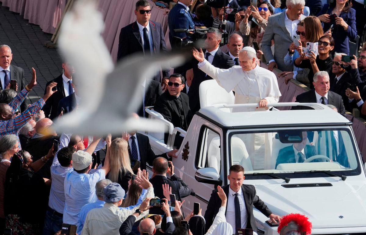 A bird flies as Pope Leo XIV arrives on the popemobile for his inaugural Mass at the Vatican, May 18, 2025. REUTERSpix