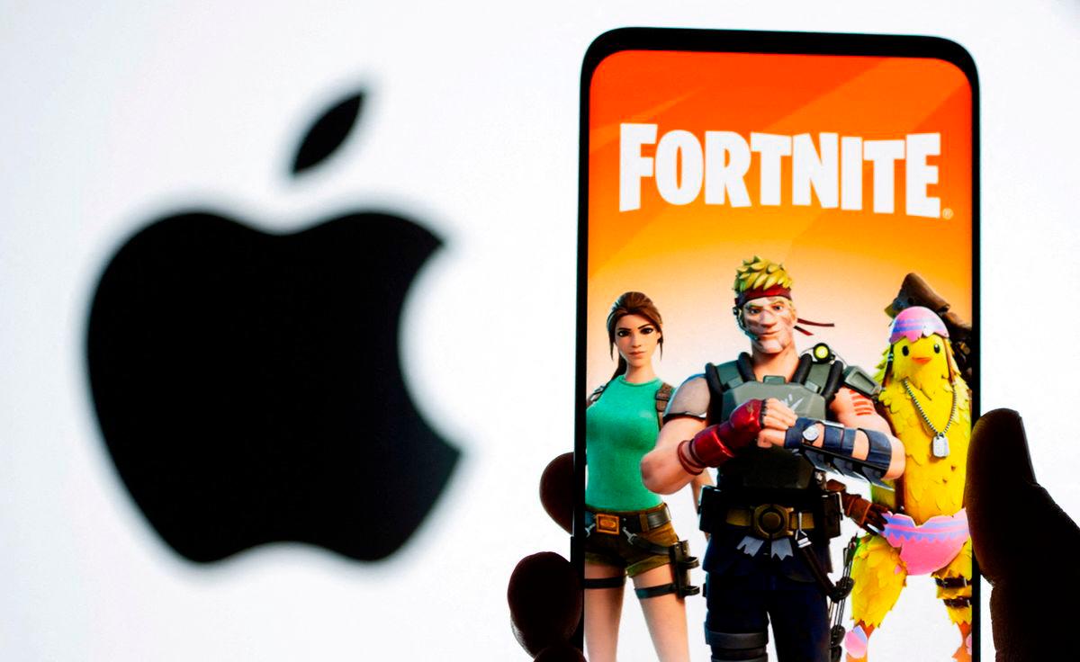 Fortnite game graphic is displayed on a smartphone in front of Apple logo in this illustration created on May 2, 2021. REUTERSpix