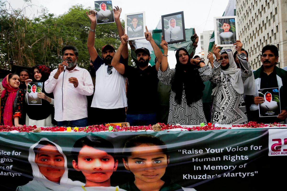 People carry pictures of the children who were killed after a suicide bomber struck an army school bus in Khuzdar district, as they gather in their memory, in Karachi, Pakistan May 21, 2025. REUTERSpix