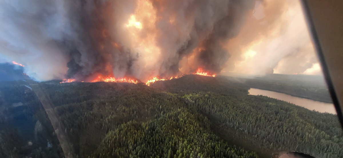 Smoke rises from the WE017 wildfire, which has prompted a state of emergency and evacuation of Sherridon, Manitoba, Canada May 27, 2025. - Handout via REUTERS.