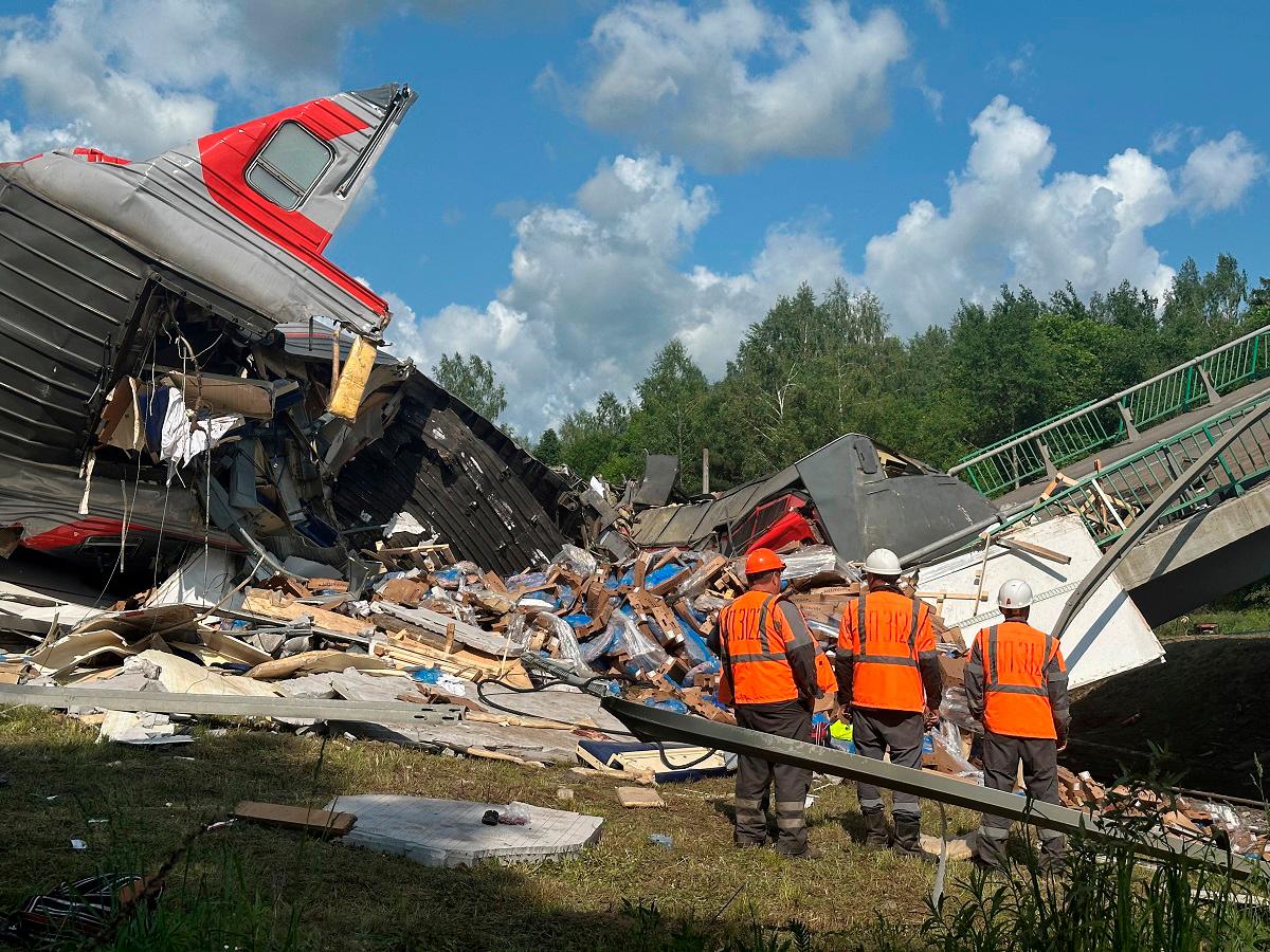 Specialists of emergency services work at the scene, after a road bridge collapsed onto railway tracks due to an explosion in the Bryansk region, Russia, June 1, 2025. - REUTERS/Stringer