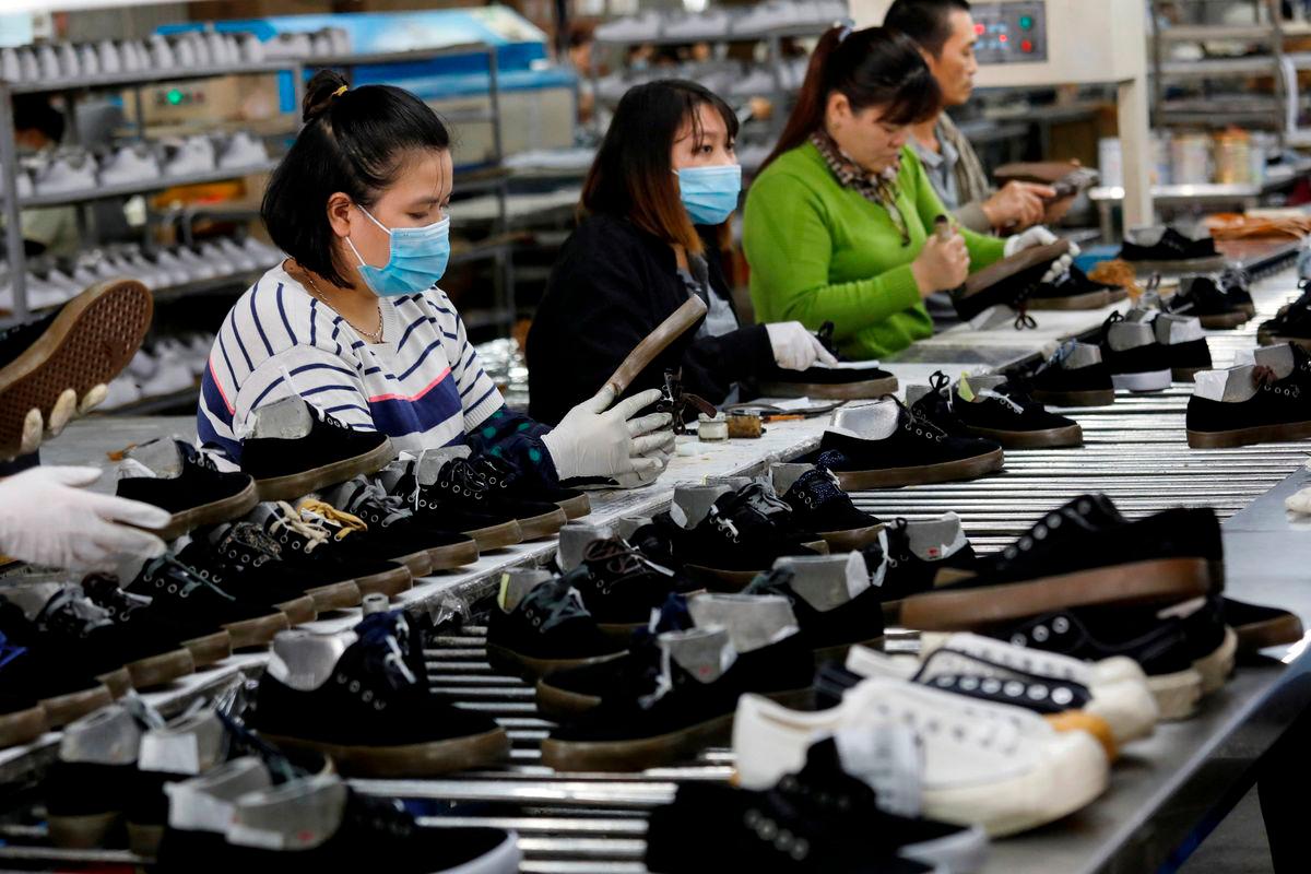 Employees work at a shoe factory for export in Hanoi, Vietnam December 29, 2020. REUTERS