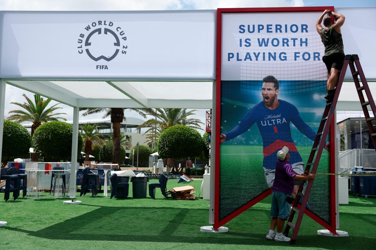 Ground staff puts up a picture of Inter Miami’s Lionel Messi ahead of the Club World Cup REUTERSpix