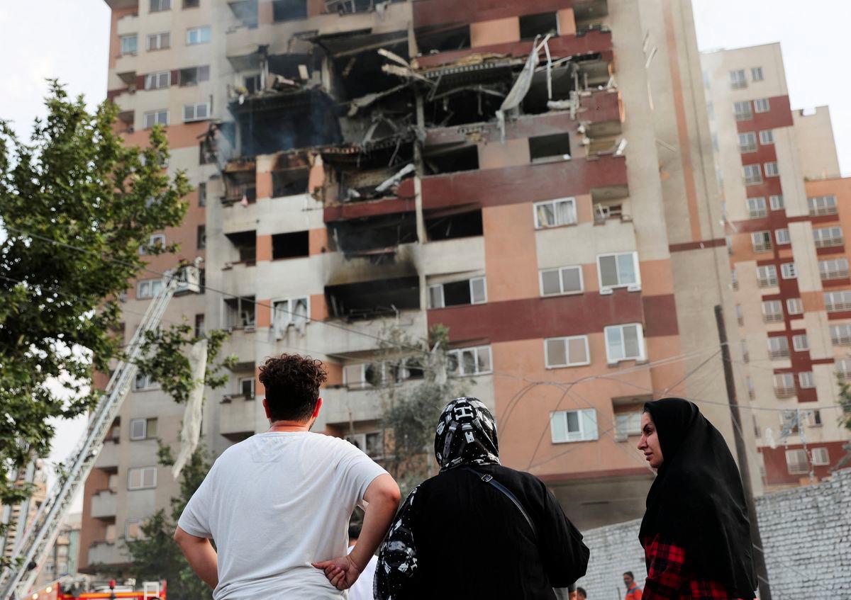 People look at a damaged building in the aftermath of Israeli strikes, in Tehran, Iran, June 13, 2025. - REUTERSPIX