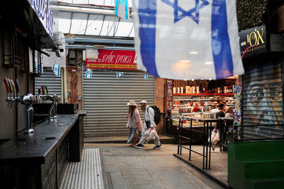 People shop in the main market as Israelis prepare against retaliation by Iran following an Israeli strike, in Jerusalem, June 13, 2025. - REUTERSPIX