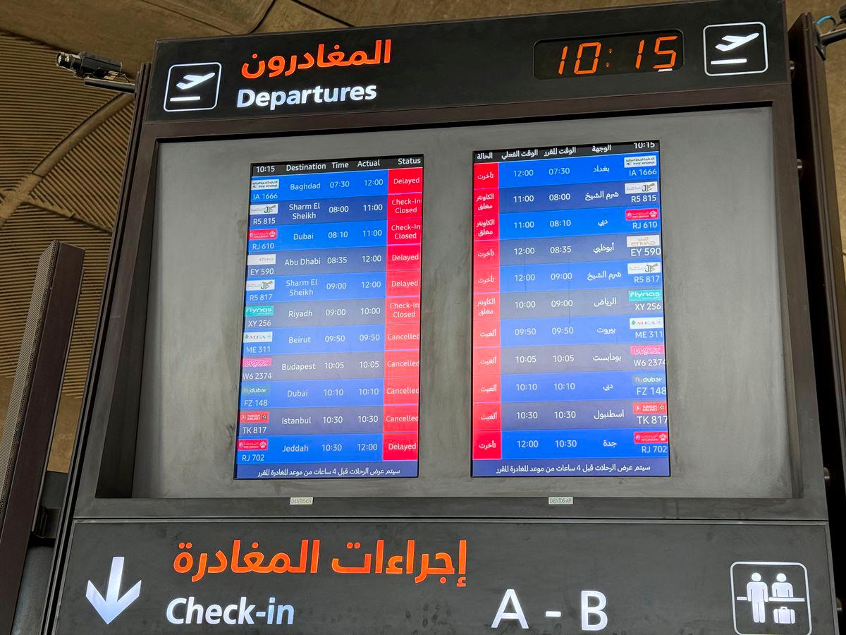 Flight information display screens show information about delayed and cancelled flights, at Queen Alia International Airport in Amman, Jordan June 13, 2025. - REUTERSPIX
