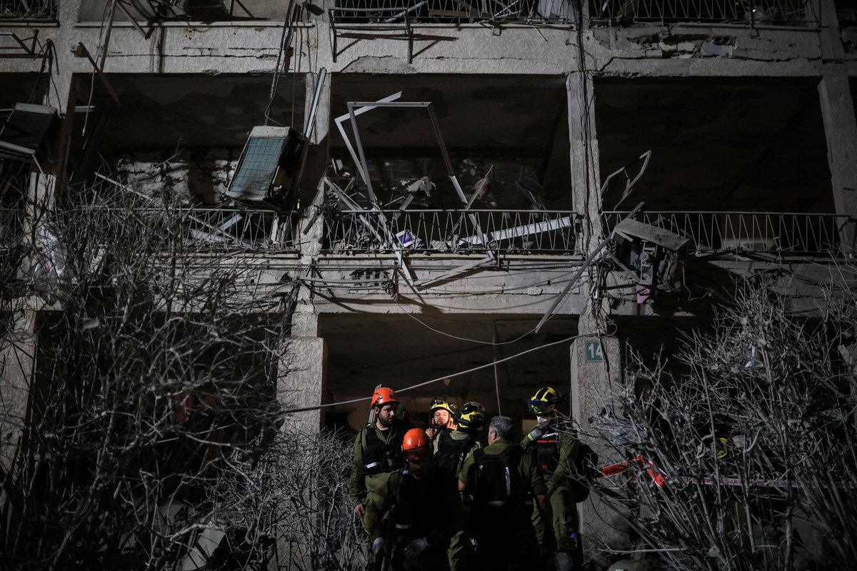 Rescue personnel work at an impact site following missile attack from Iran on Israel, in Ramat Gan June 13, 2025. - REUTERSpix