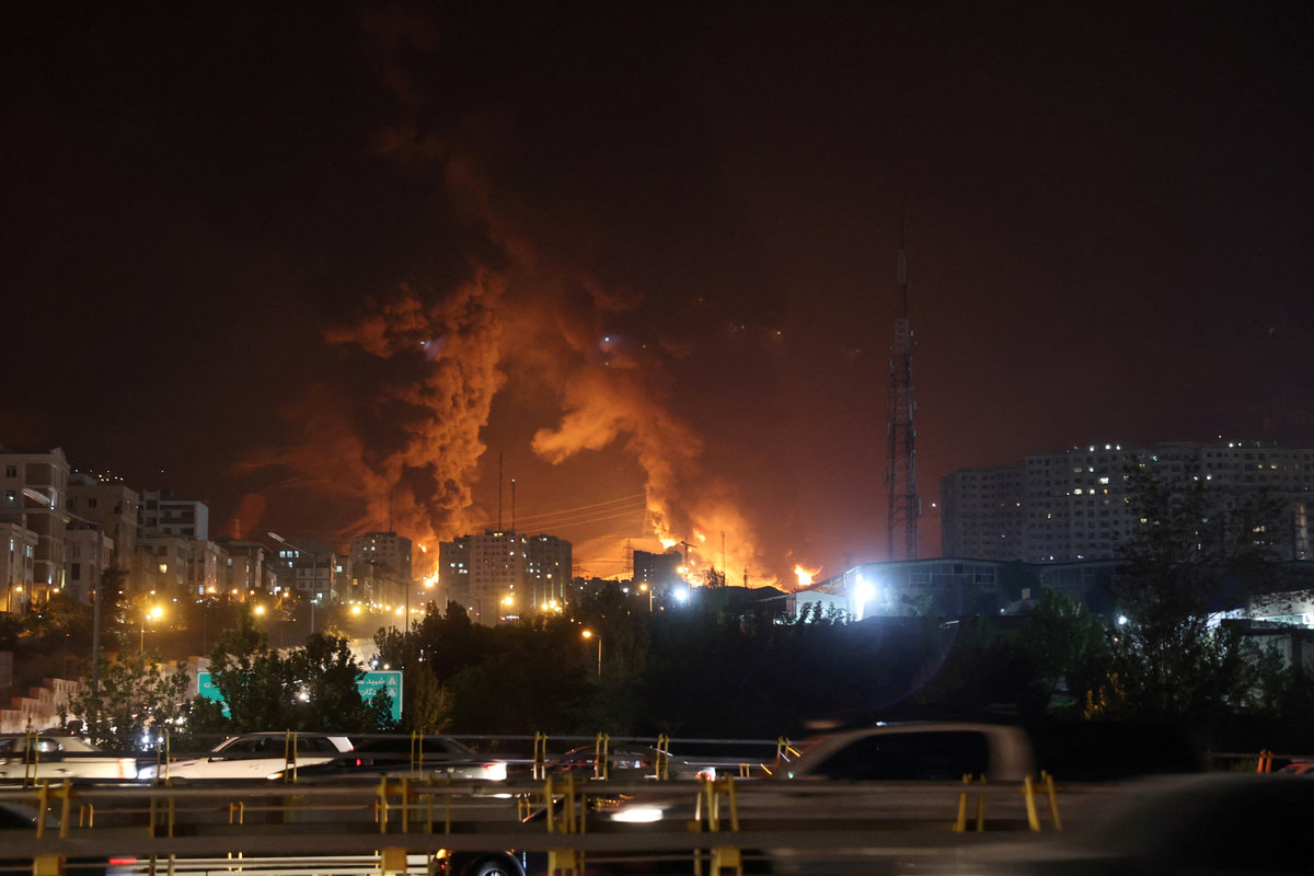 Smoke from an Israeli attack rise from Sharan Oil depot, following Israeli strikes on Iran, in Tehran, Iran, June 15, 2025. - via REUTERS