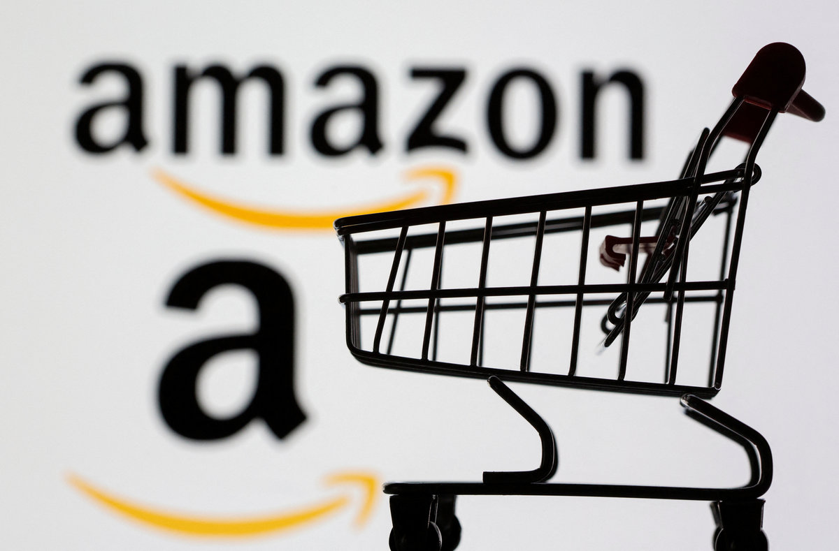 Small toy shopping cart is seen in front of displayed Amazon logo in this illustration taken, July 30, 2021. 0 REUTERS