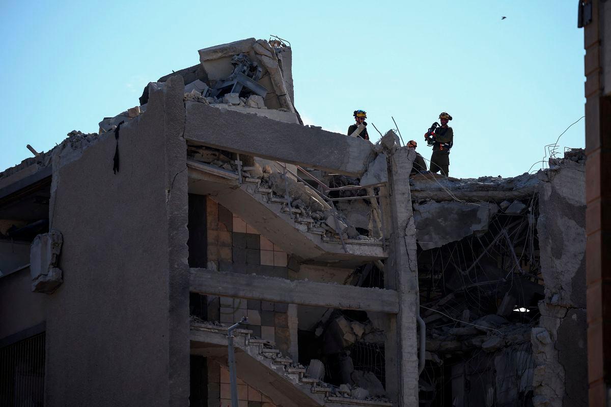 Emergency personnel work at an impact site following Iran's missile strike on Israel, amid the Iran-Israel conflict, in Haifa, Israel, June 20, 2025. - REUTERSPIX