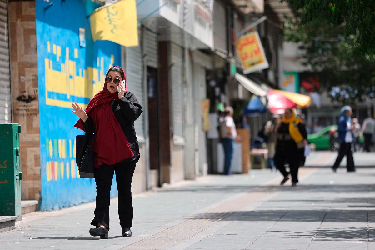 A woman walks on a street, during early hours of ceasefire, in Tehran, Iran, June 24, 2025. - Majid Asgaripour/WANA (West Asia News Agency) via REUTERS