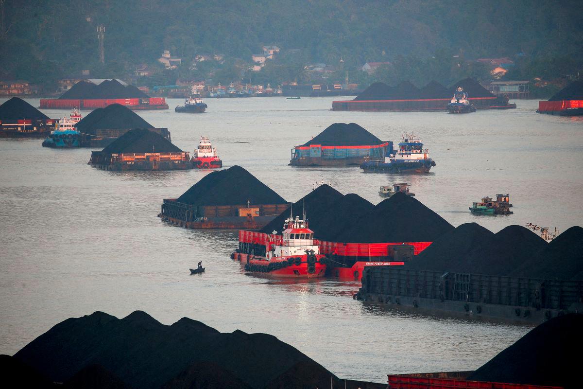 Coal barges are pictured as they queue to be pulled along Mahakam river in Samarinda, East Kalimantan province, Indonesia, August 31, 2019. - REUTERSPIX