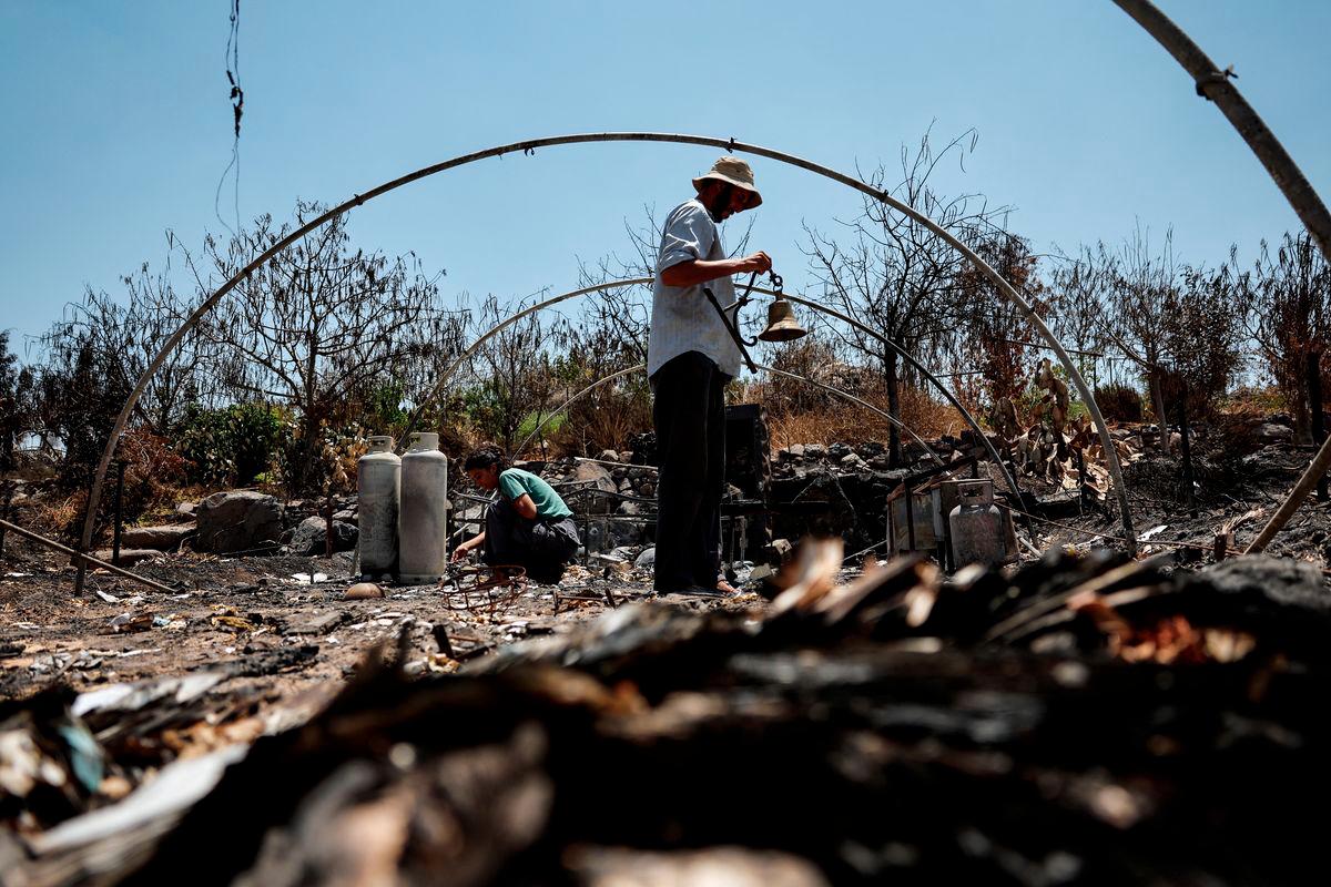 Livluv Melnikov, 33, check a burnt part of his farm where missile attack from Iran last week lit a fire that eventually, with wind support, totally burnt the farm, near Yavneel, Israel June 25, 2025. - REUTERSPIX