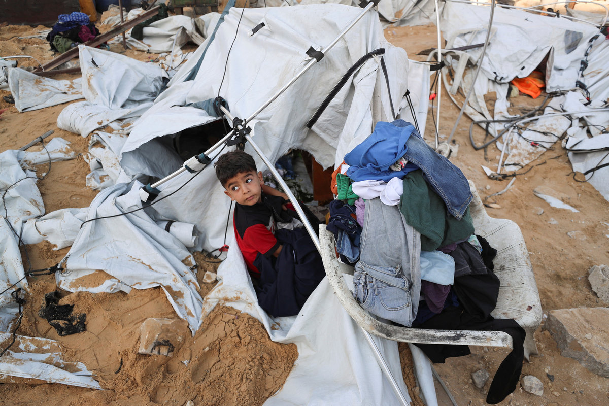 A Palestinian child looks on at the site of a tent camp that was struck by an Israeli airstrike on Friday, in Gaza City, June 28, 2025. - REUTERS