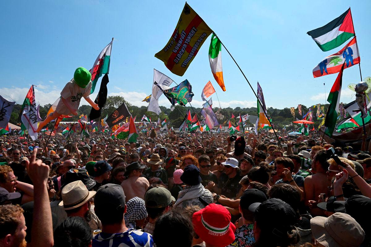 Revellers gather as Kneecap performs at Glastonbury Festival at Worthy Farm in Pilton, Somerset, Britain, June 28, 2025. REUTERS/Jaimi Joy/File Photo