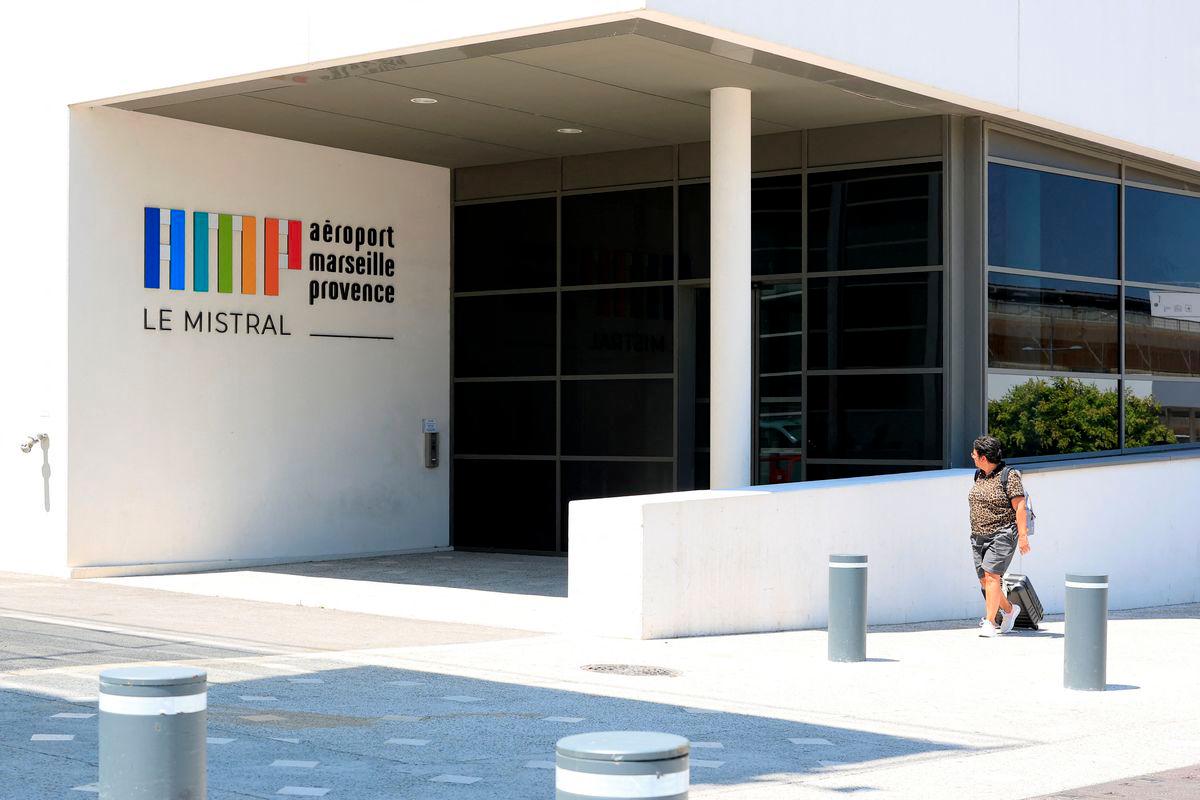 A traveler carrying luggage walks outside the Marseille-Provence airport on the eve of a strike call by two air traffic controllers' unions to defend their working conditions, in Marignane, near Marseille, France, July 2, 2025. - REUTERSPIX