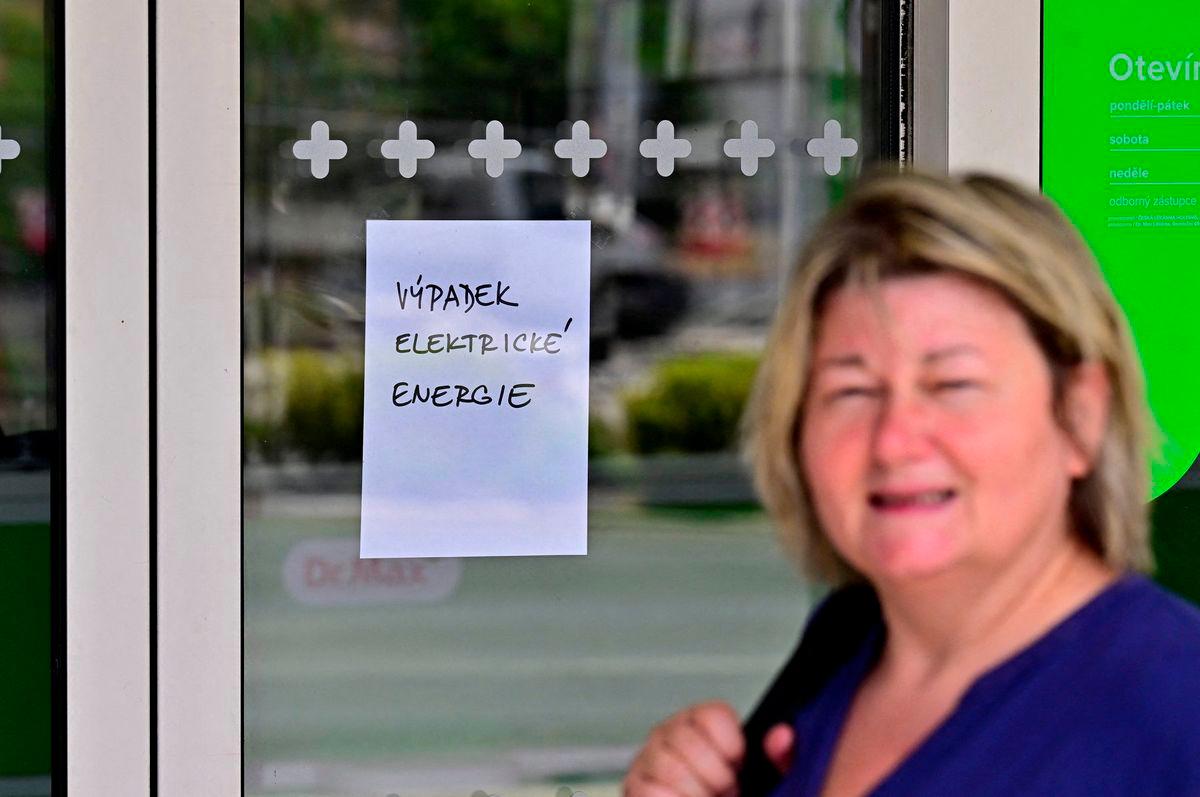 A woman walks past by pharmacy closed due to a major power outage in Usti nad Labem, Czech Republic, July 4, 2025. The text reads Outage of electric energy. - CTK/Hajek Ondrej via REUTERSPIX