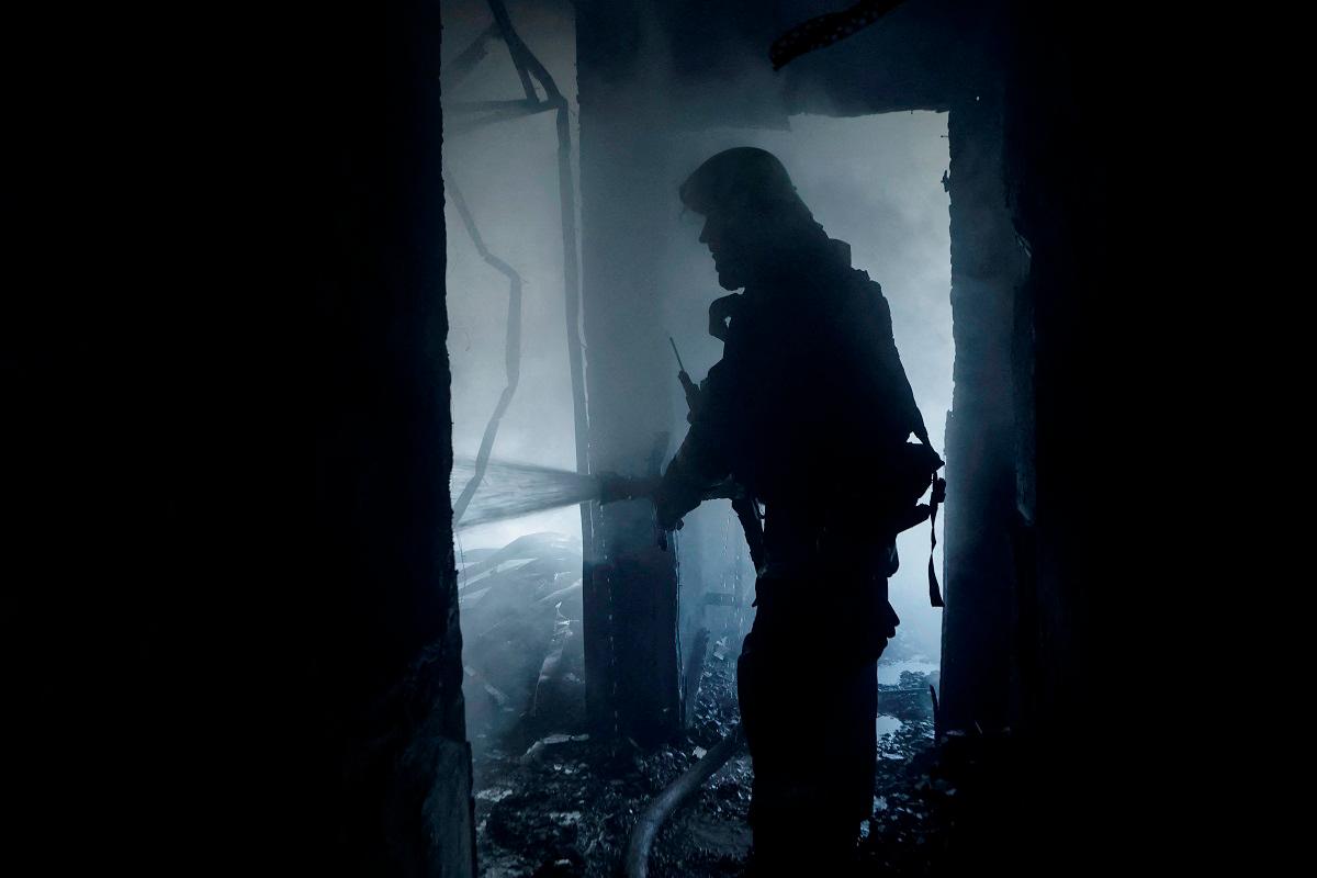 A firefighter works at the site of the building hit by a Russian drone strike, amid Russia’s attack on Ukraine, in Kharkiv, Ukraine July 7, 2025. - REUTERS/Sofiia Gatilova