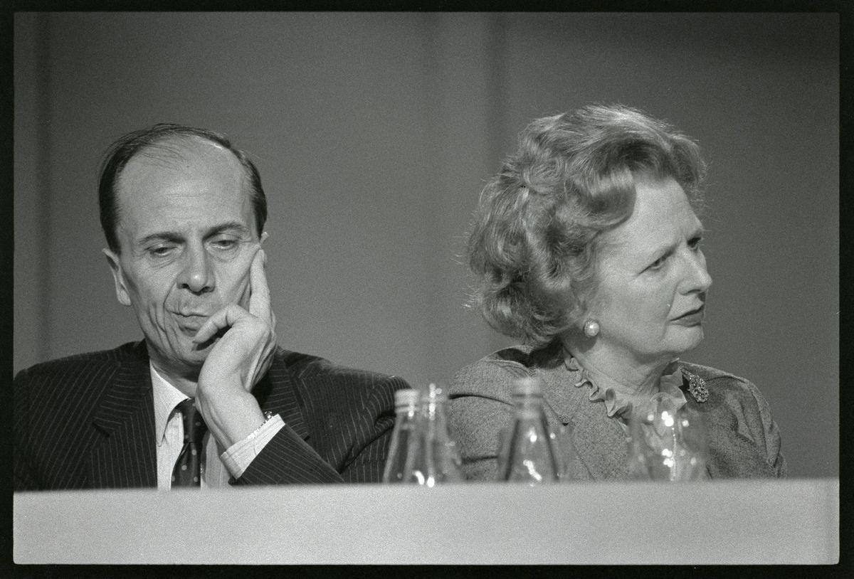 Britain’s Prime Minister Margaret Thatcher listens to speeches with Conservative Party Chairman Norman Tebbit at the Party Conference in Blackpool, England. October 10, 1985 REUTERS/Roy Letkey/File Photo.