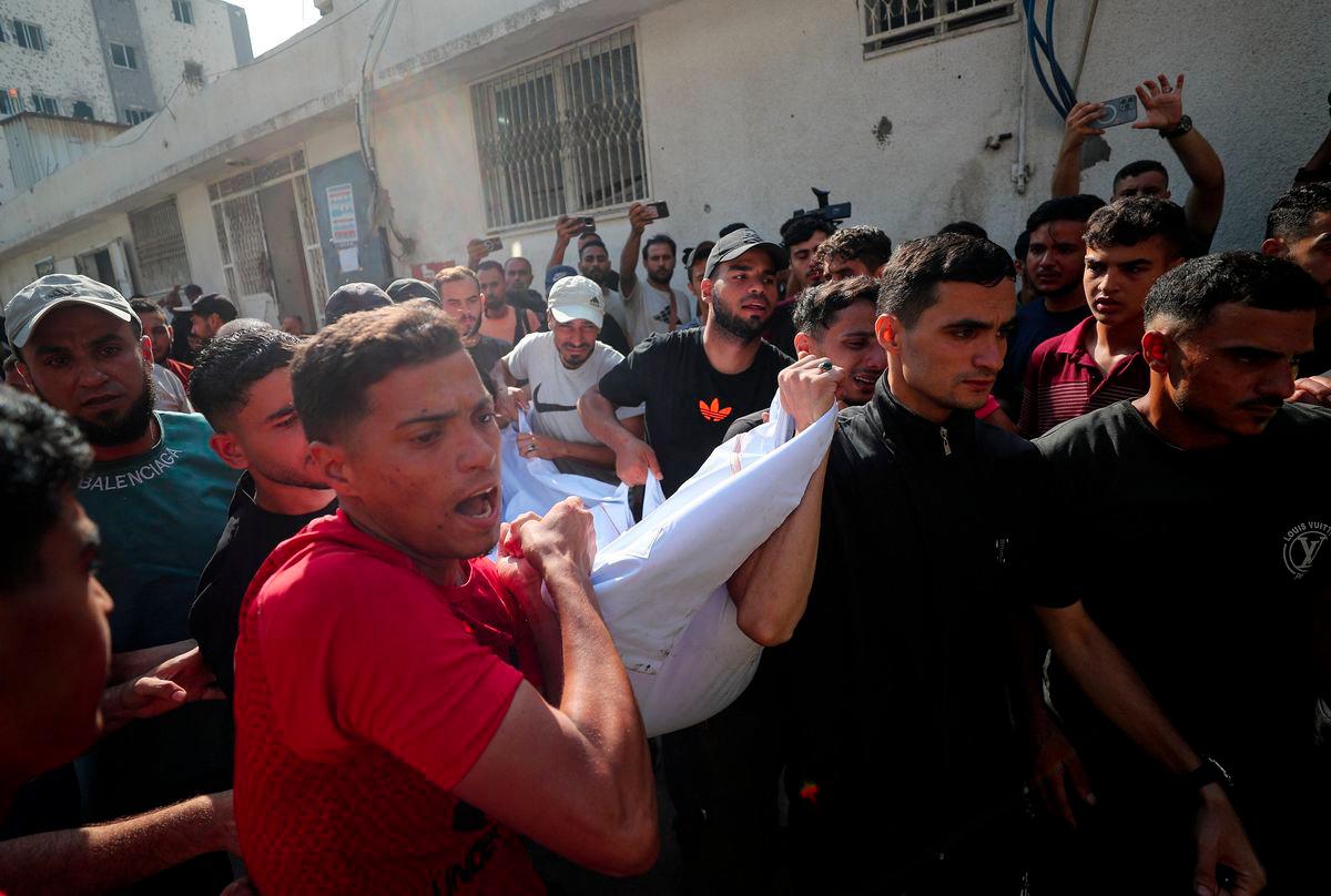 Mourners carry a body as they attend the funeral of Palestinians killed in overnight Israeli strikes, according to medics, at Al-Shifa Hospital in Gaza City, July 11, 2025. - REUTERSPIX