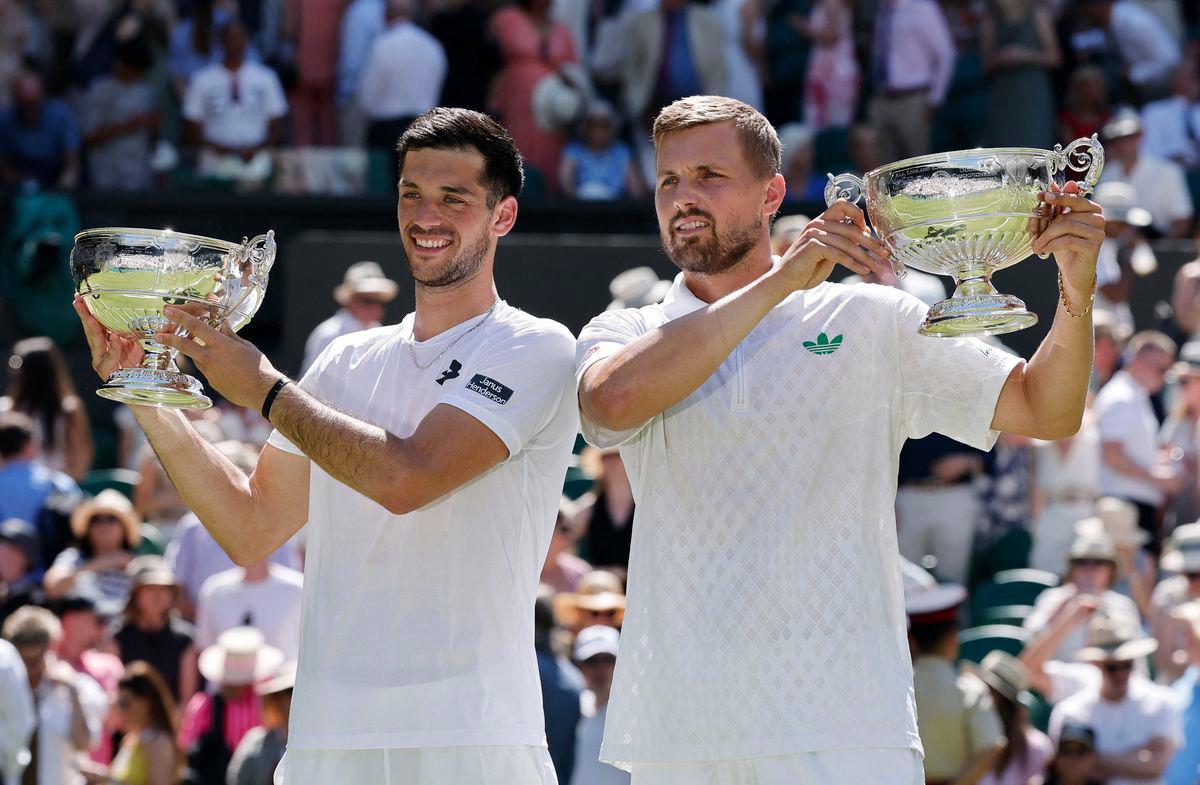 Tennis - Wimbledon - All England Lawn Tennis and Croquet Club, London, Britain - July 12, 2025Britain's Lloyd Glasspool and Julian Cash pose with their trophies after winning the men's doubles final against Australia's Rinky Hijikata and Netherlands' David Pel - REUTERSPIX