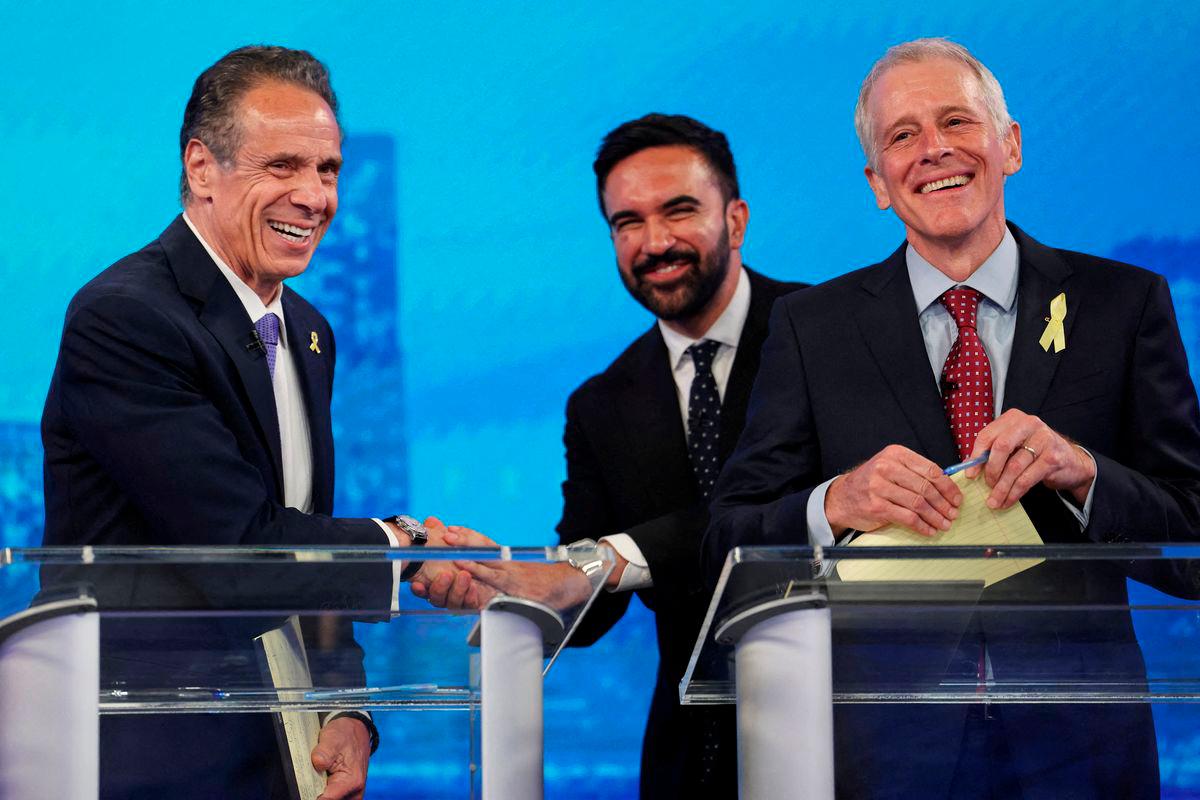 Democratic mayoral candidates Andrew Cuomo shakes hands with Zohran Mamdani as Whitney Tilson reacts, after participating in a Democratic mayoral primary debate - Yuki Iwamura/Pool via REUTERSpix