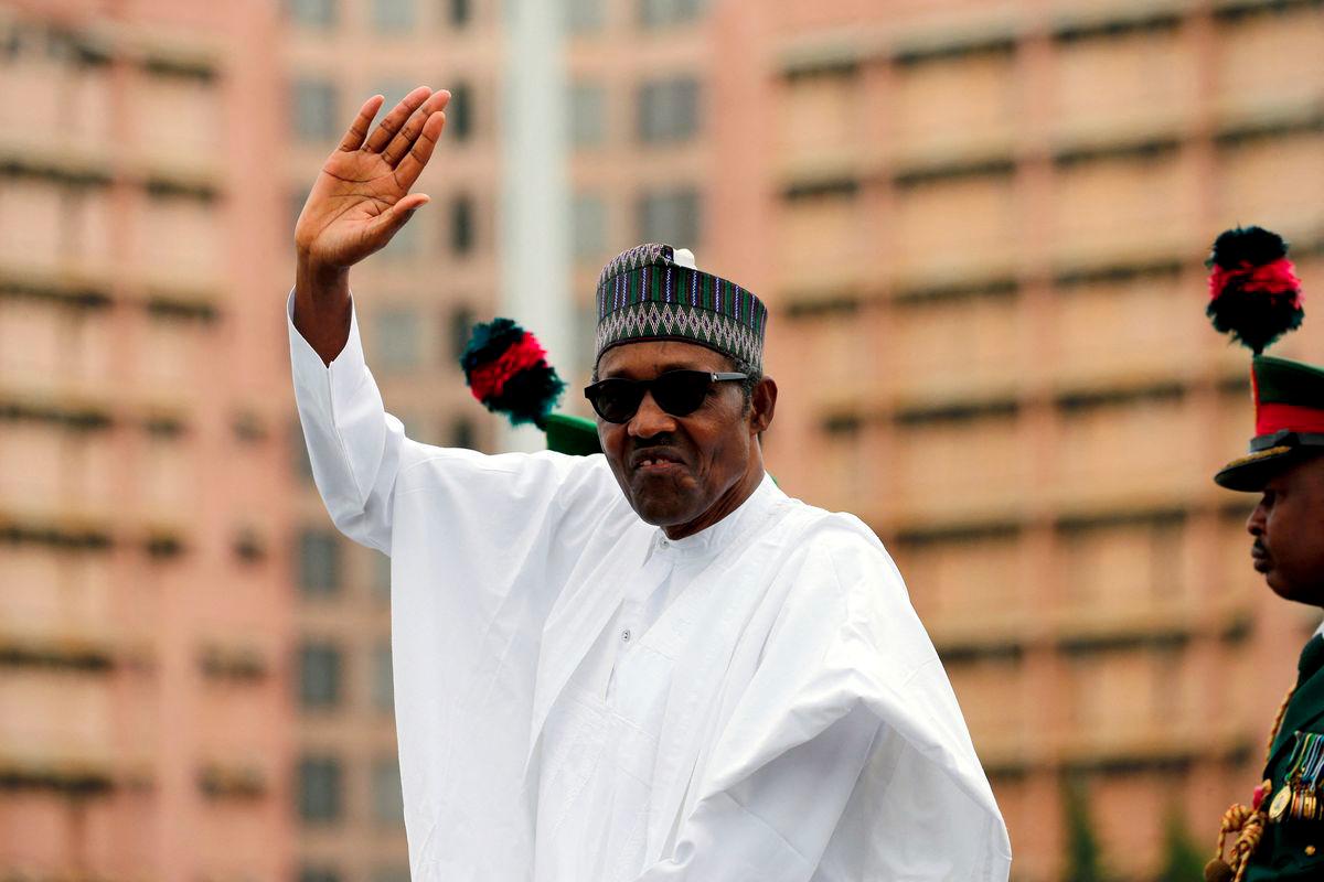 Nigerian President Muhammadu Buhari waves at the crowd while he drives around the venue during his inauguration for a second term in Abuja, Nigeria, May 29, 2019. - REUTERSPIX