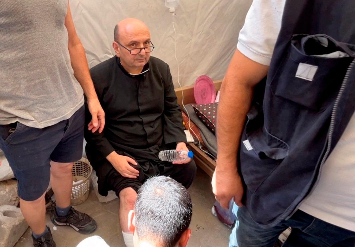 Parish priest of the Church of the Holy Family, father Gabriele Romanelli, receives medical attention, after he suffered light leg injuries following an Israeli strike on the church, according to medics, at Al-Ahli Arab Hospital in Gaza City, in this still image taken from a video July 17, 2025. - REUTERS/Dawoud Abu Alkas