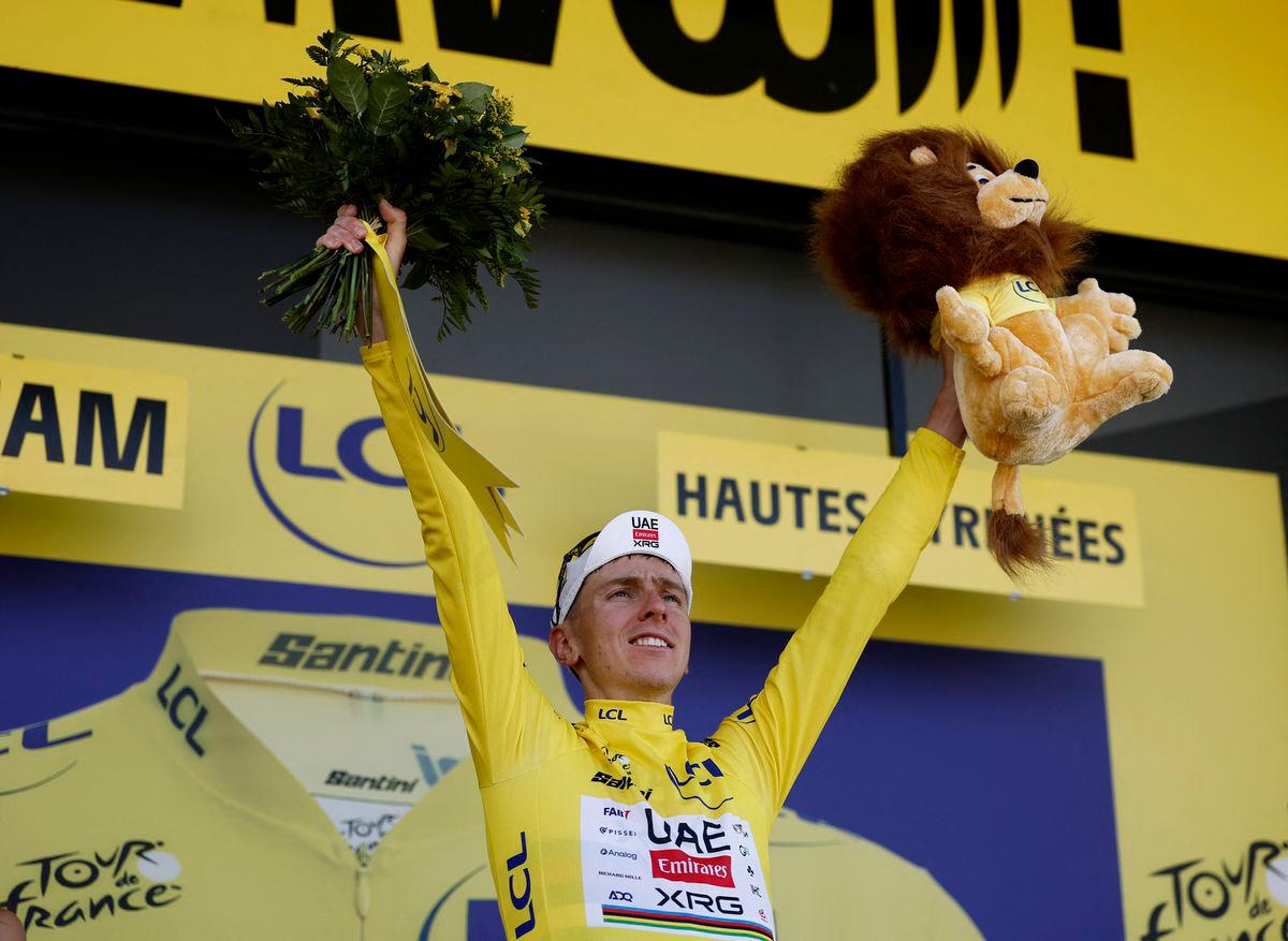UAE Team Emirates XRG’s Tadej Pogacar celebrates on the podium wearing the yellow jersey after winning stage 12 - REUTERS