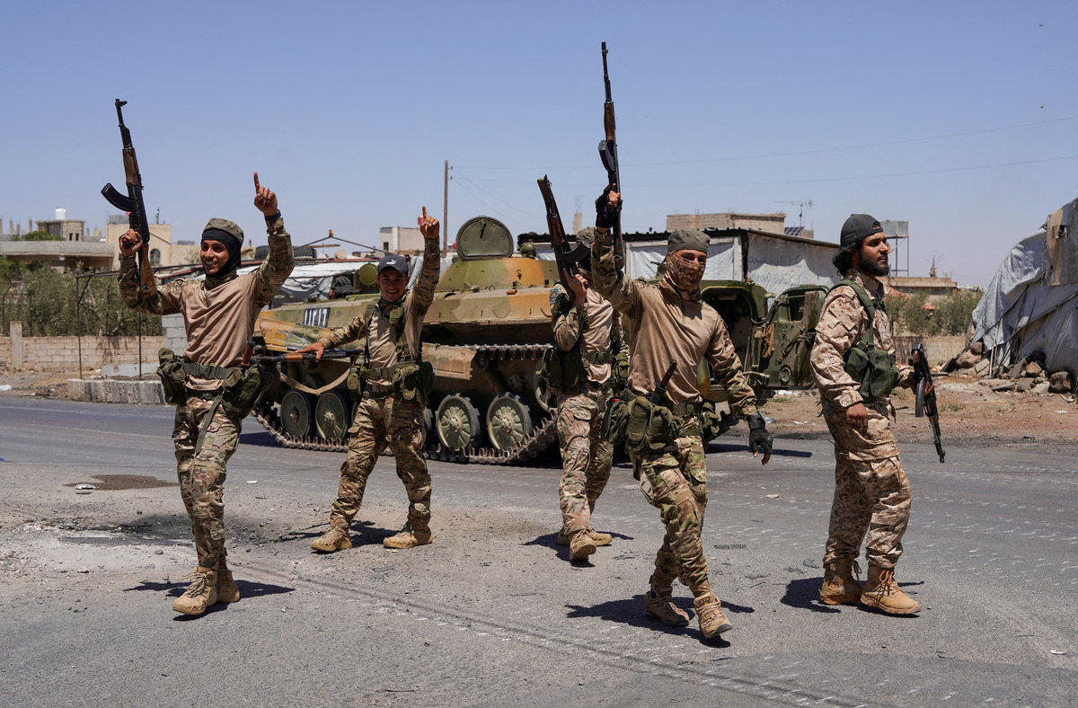 Syrian security forces walk together along a street, after clashes between Syrian government troops and local Druze fighters resumed in the southern Druze city of Sweida early on Wednesday, collapsing a ceasefire announced just hours earlier that aimed to put an end to days of deadly sectarian bloodshed, in Sweida, Syria July 16, 2025. - REUTERS