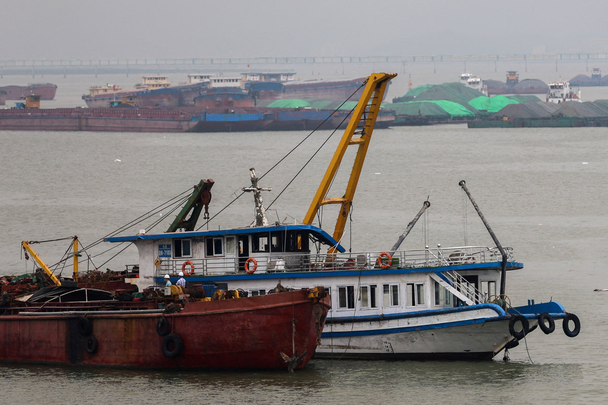 A tourist boat (in white) that capsized in an accident which killed dozens and left several people still missing, is towed back to the port in Halong Bay, Quang Ninh province, Vietnam, July 20, 2025. - REUTERS